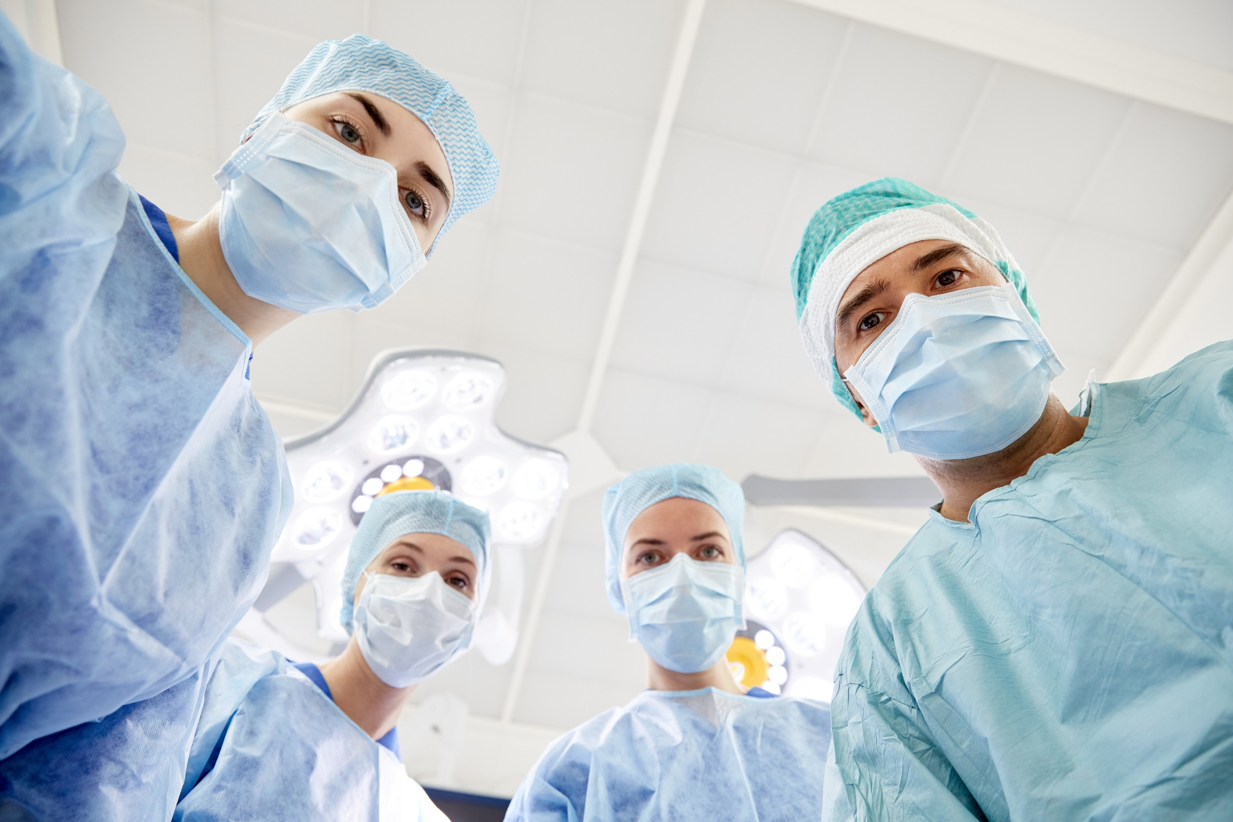 group of surgeons in operating room at hospital Surgical Techs